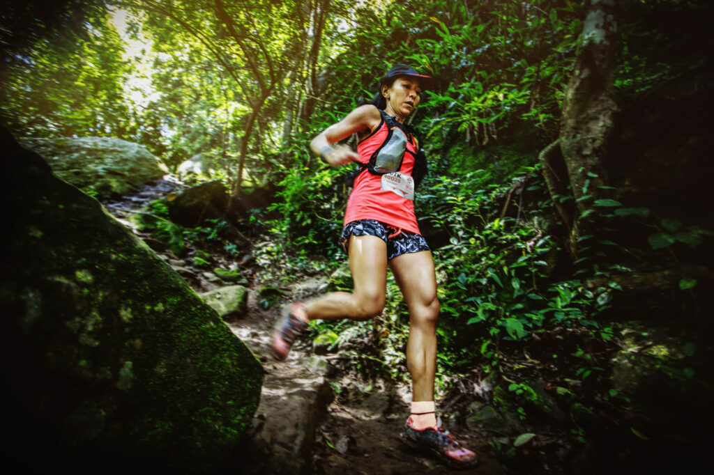 female runner descending mountain trail
